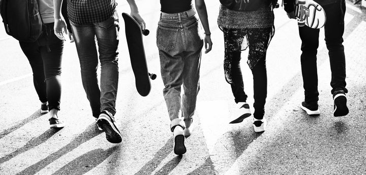 A group of teenagers walking away from the camera