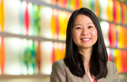 Headshot of Dr. Julie Wei against a colorful background