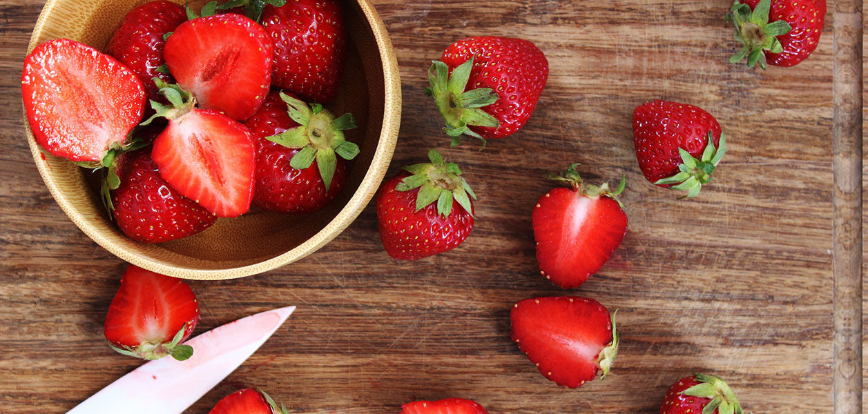 Strawberries in a bowl and on a cutting board
