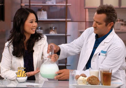 Dr. Julie Wei sitting beside a man and demonstrating acid reflux on The Doctors TV Show