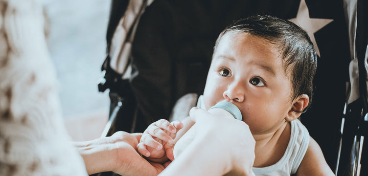 Baby being fed by bottle