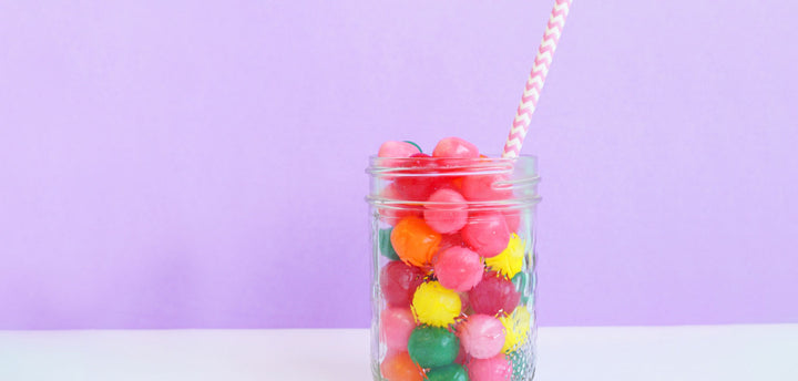 Candy in a glass jar with a straw