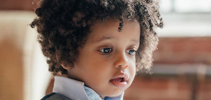 Face of a young boy with curly hair