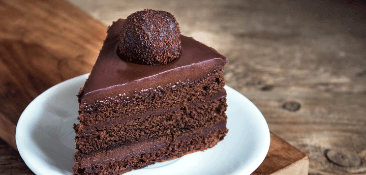 A piece of chocolate cake on a white plate