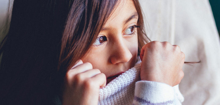 Girl covering her mouth with her shirt