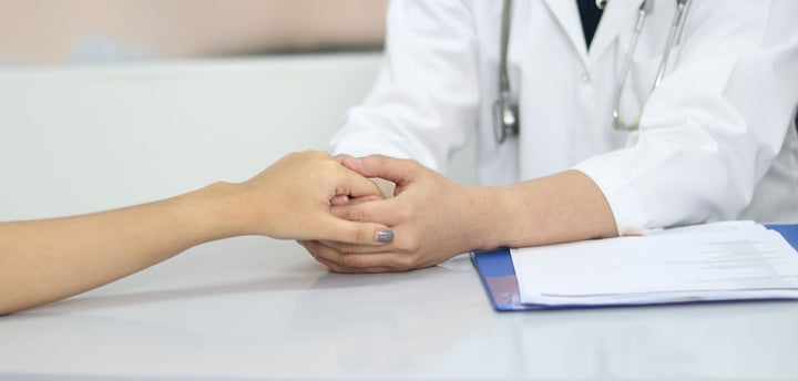 Doctor holding a patient's hand