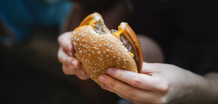 Person holding a hamburger