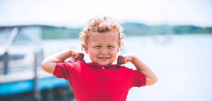 Little boy flexing his muscles