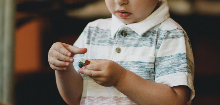Boy with a piece of lego