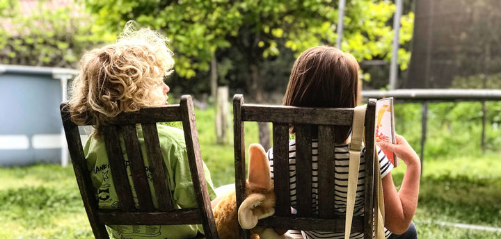 Two kids on chairs outside