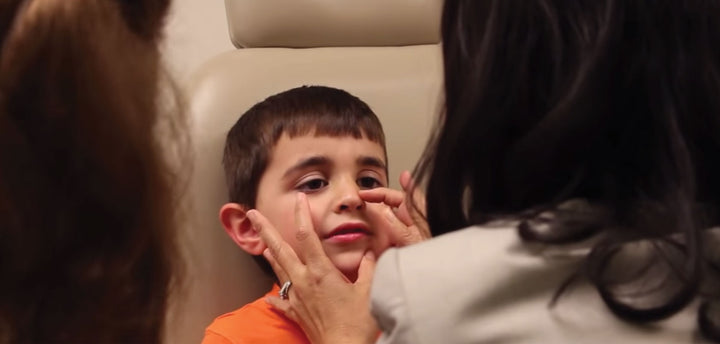 Doctor examining a child's nose