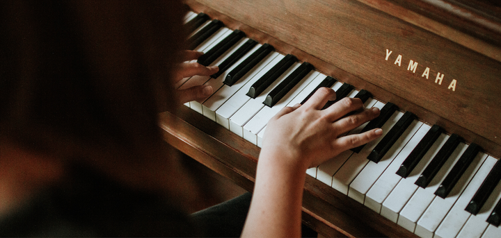 Woman playing a Yamaha piano