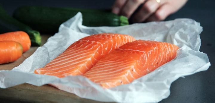 Two salmon filets on a cutting board