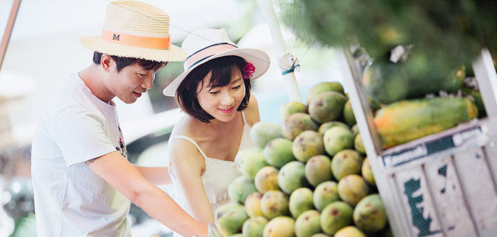 A man and woman shopping for fruit