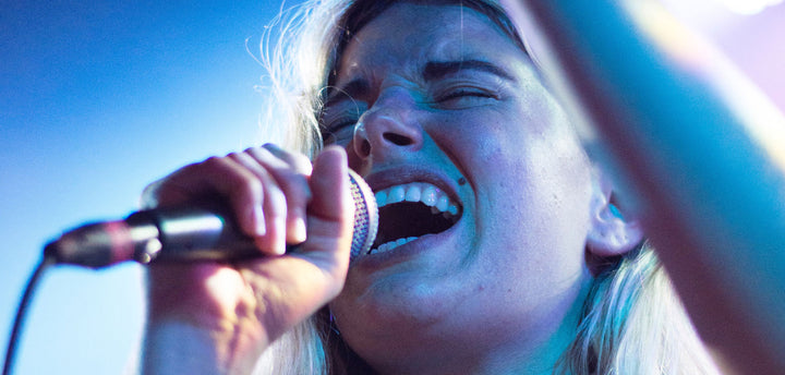 Woman singing into a microphone