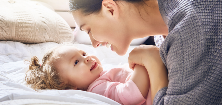 Mother and daughter smiling