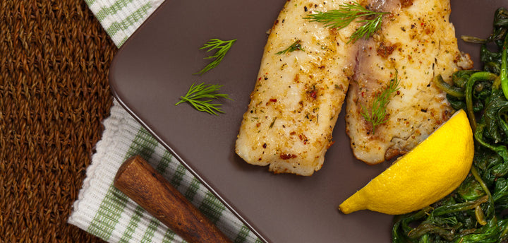 Tilapia on a plate with a lemon wedge