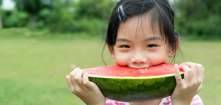 Young girl eating watermelon