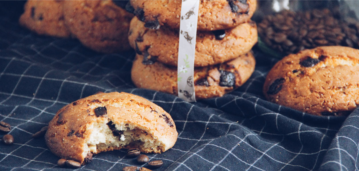 Chocolate chip cookies on a blue cloth with subtle white stripes